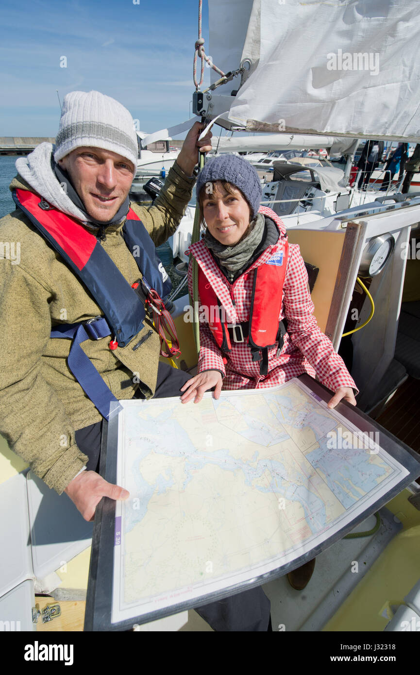 Stralsund, Germany. 2nd May, 2017. Alexander Holtz and his partner Corrina Hoffmann on the Vacuna, an eight metre long sailing vessel which will be home to the two explorers over the course of a 100-day Baltic expedition, in Stralsund, Germany, 2 May 2017. Holtz, a trained chimney sweep, and Hoffmann, a biologist, plan on stops in Stockholm, Helsinki, Riga, Danzig, St. Petersburg and Kaliningrad. They are hoping both for scenic views and plenty of wildlife. Strong winds delayed their departure for a day. Photo: Stefan Sauer/dpa-Zentralbild/dpa/Alamy Live News Stock Photo