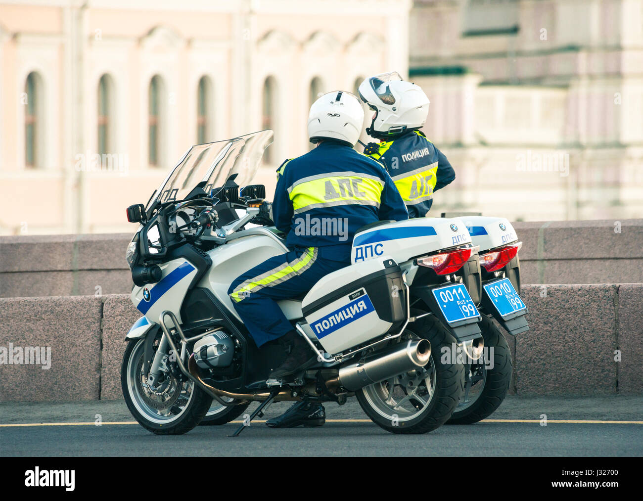 russian traffic policemen on their patrol motorcycles talking Stock Photo