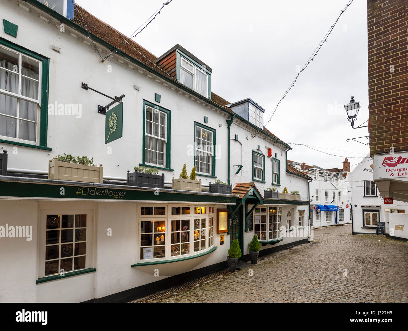 Elderflower Restaurant in cobbled Quay Street with quaint local shops and houses leading to the harbour, Lymington, Hampshire, south coast of England Stock Photo