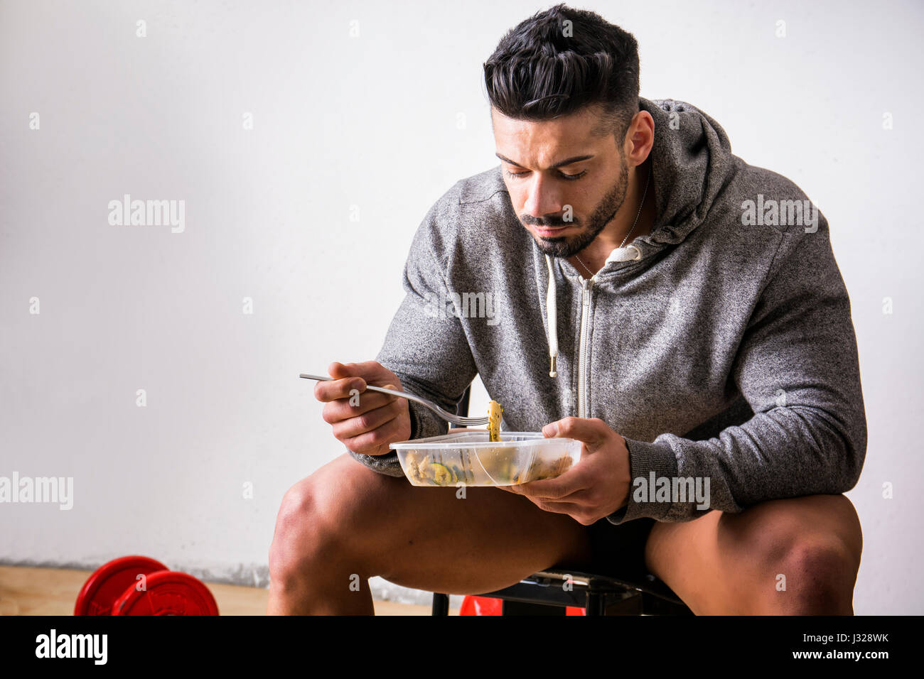 Hungry muscular man gulping down food Stock Photo Alamy
