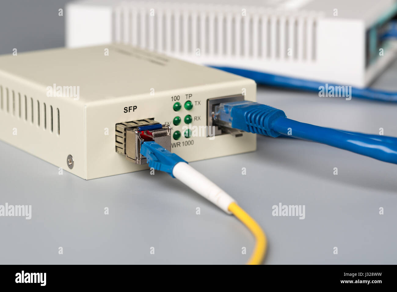 1Gbps optical media converter with SFP module connected to ethernet port  SOHO router Stock Photo - Alamy