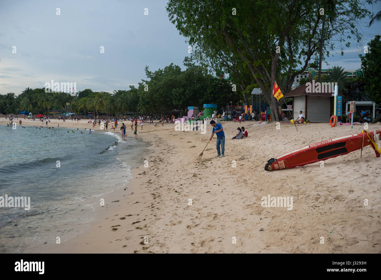 02.04.2017, Singapore, Republic of Singapore, Asia - A worker is seen cleaning a part of the Palawan Beach on Sentosa Island. Stock Photo