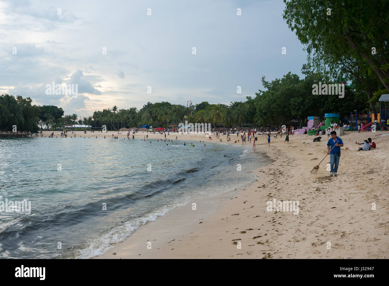 02.04.2017, Singapore, Republic of Singapore, Asia - A worker is seen cleaning a part of the Palawan Beach on Sentosa Island. Stock Photo