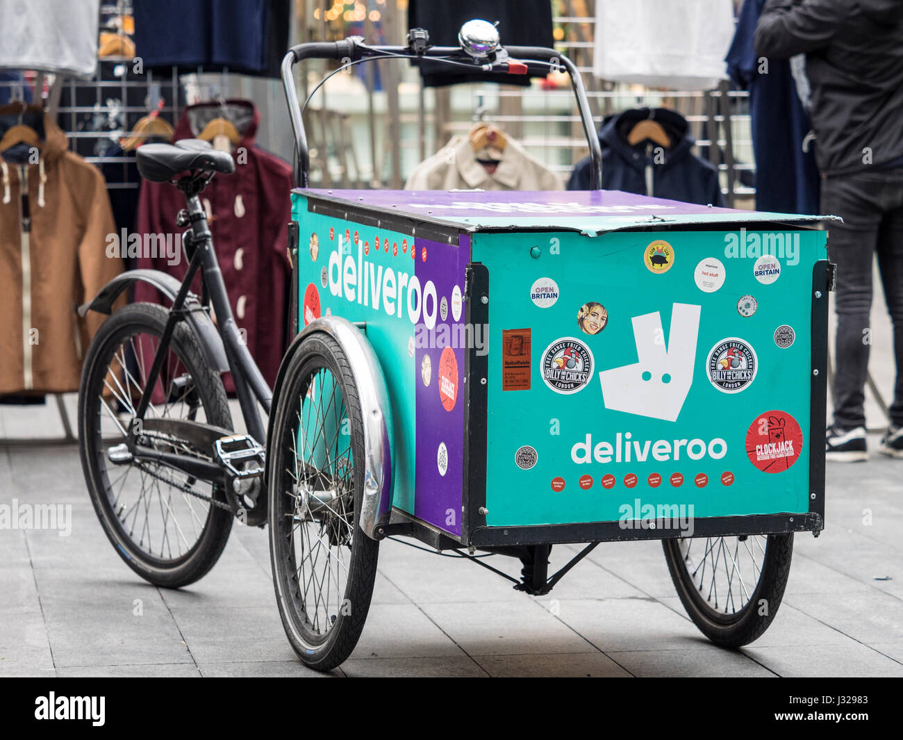 A large capacity Deliveroo cargo bike parked in Central London. Deliveroo is one of the firms in the competitive food delivery business in the UK. Stock Photo