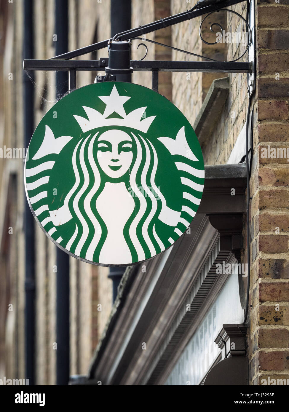 A hanging Starbucks Coffee sign in London's East End Stock Photo