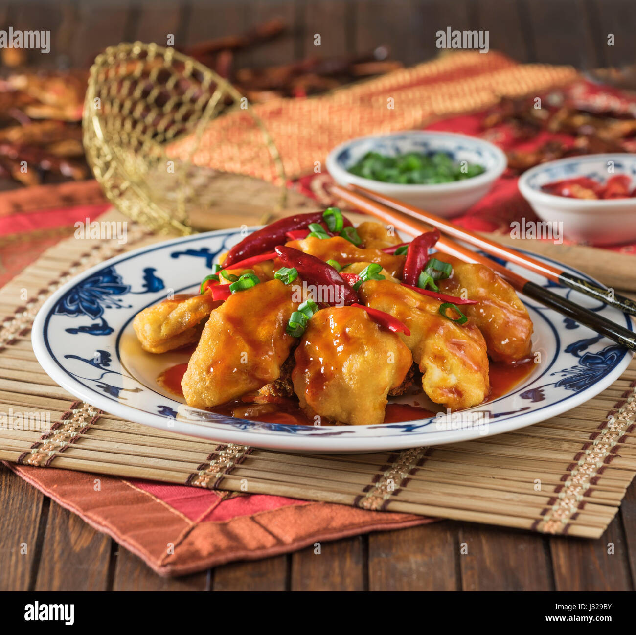 Firecracker chicken. Spicy fried chicken in a hot chilli sauce. Chinese food. Stock Photo
