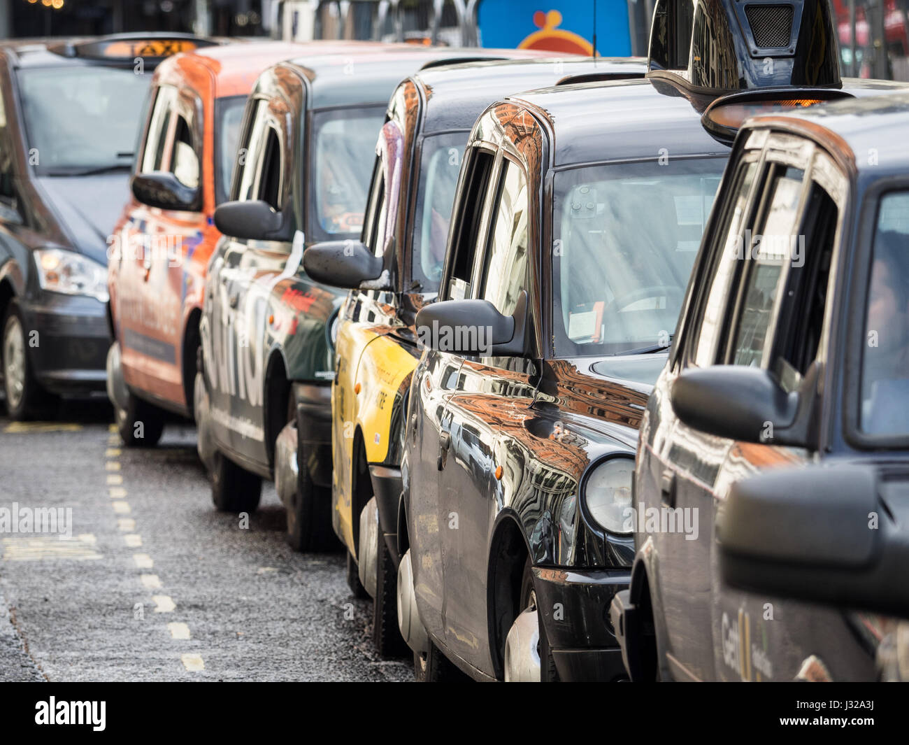 London taxis Black Cabs queue for customers near Liverpool Street station in Central London. Stock Photo