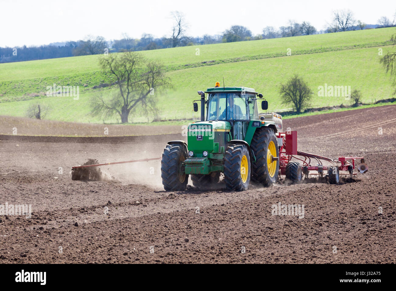 Sowing on the Cotswolds in early spring near Hawling, Gloucestershire UK Stock Photo