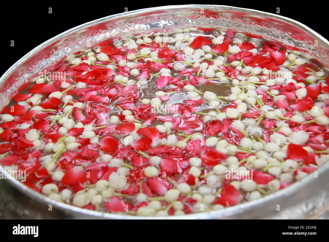 group of Thai garland flowers and water with jasmine and roses corolla in bowl isolated on white background, use for Songkran festival in Thailand Stock Photo
