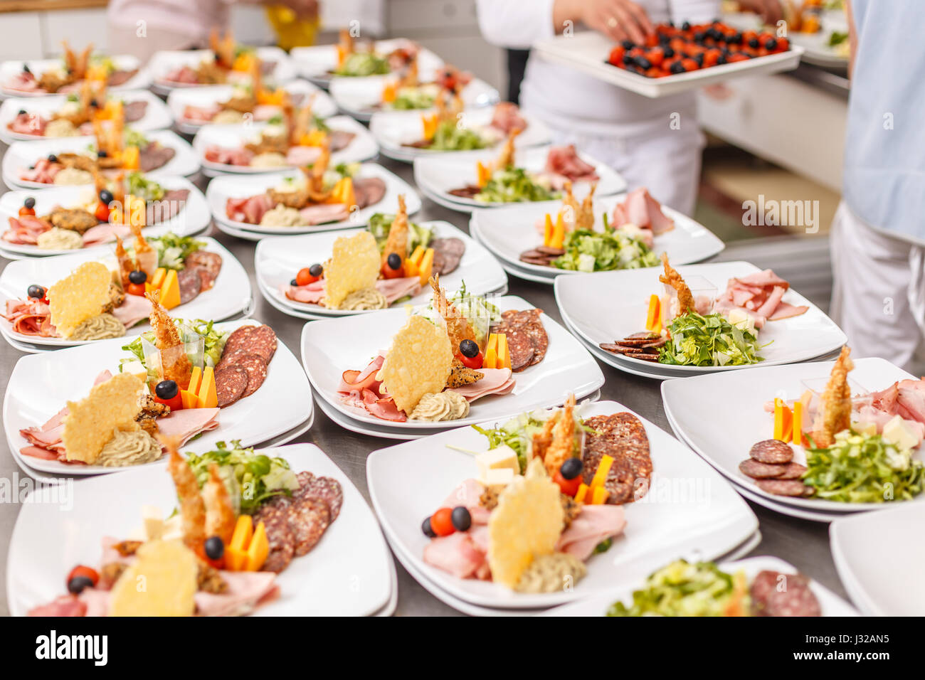 Lot of appetizer food plates in a restaurant kitchen. Stock Photo
