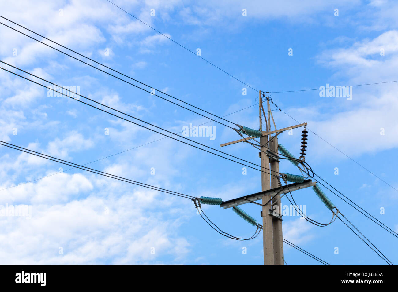 Electric pole with blue sky and white cloud Stock Photo - Alamy