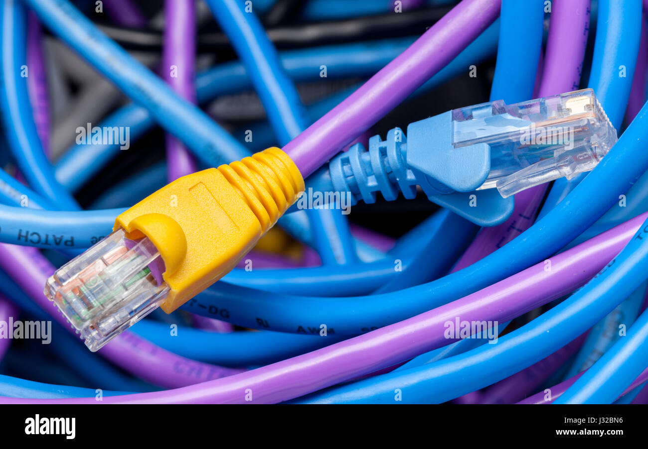 Plugs on cat5e ethernet cables and coloured network cables Stock Photo