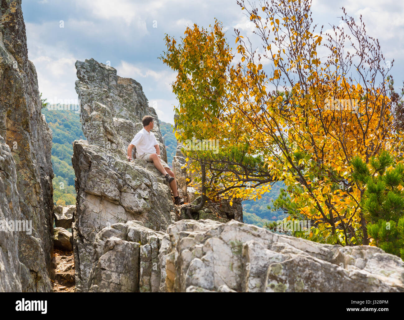 Man at the summit of the rocky granite mountain top of Seneca Rocks in West Virginia, USA Stock Photo