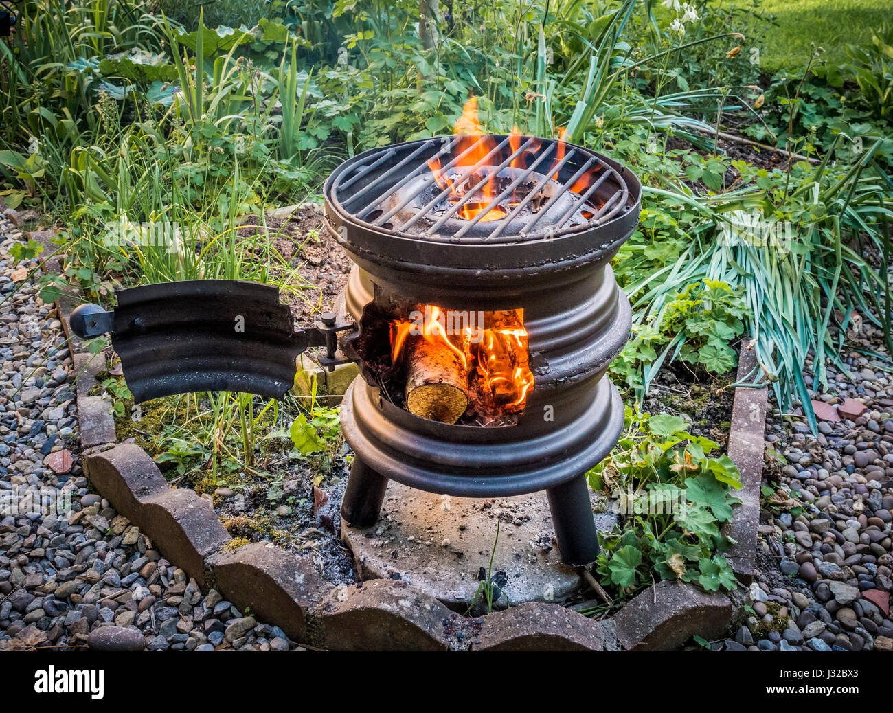 Upcycled car wheels turned into wood burning barbecue stove Stock Photo