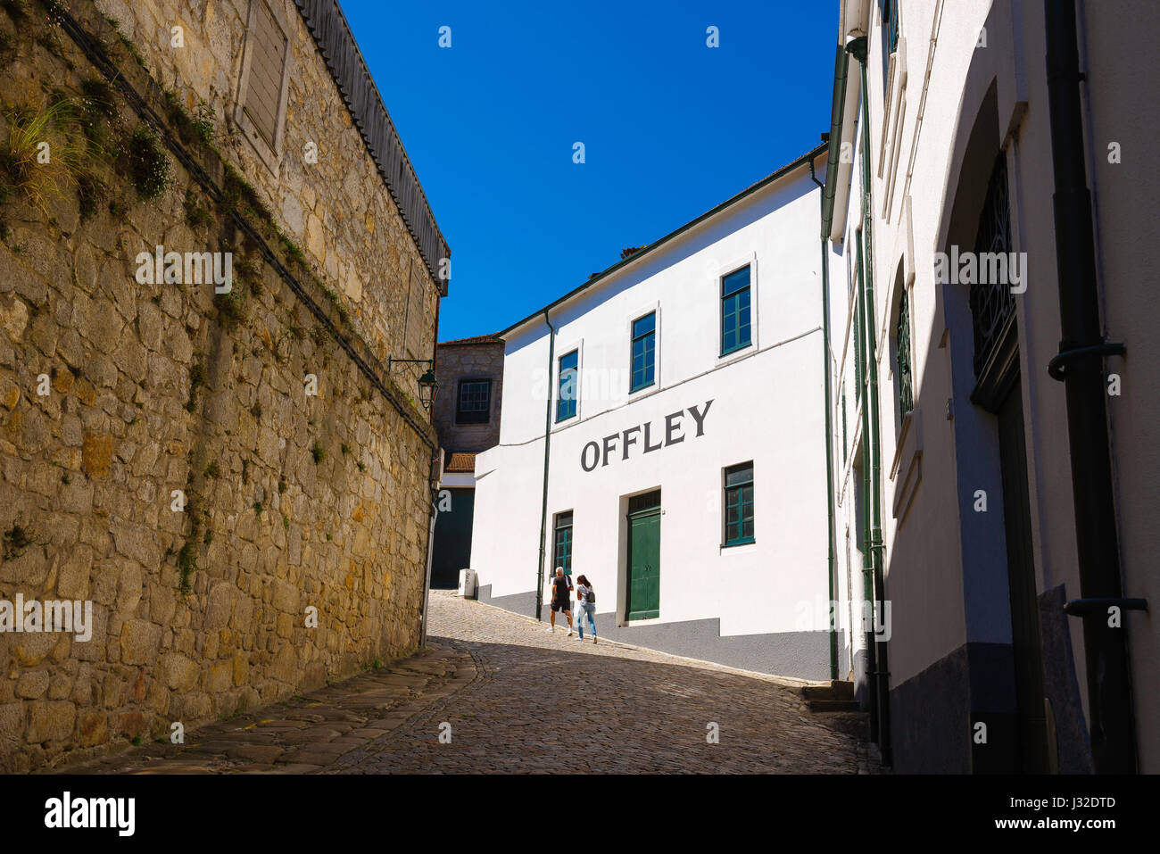 Porto wine lodge, view of a couple making their way to a port wine lodge behind the waterfront in the Vila Nova de Gaia area of Porto, Portugal. Stock Photo