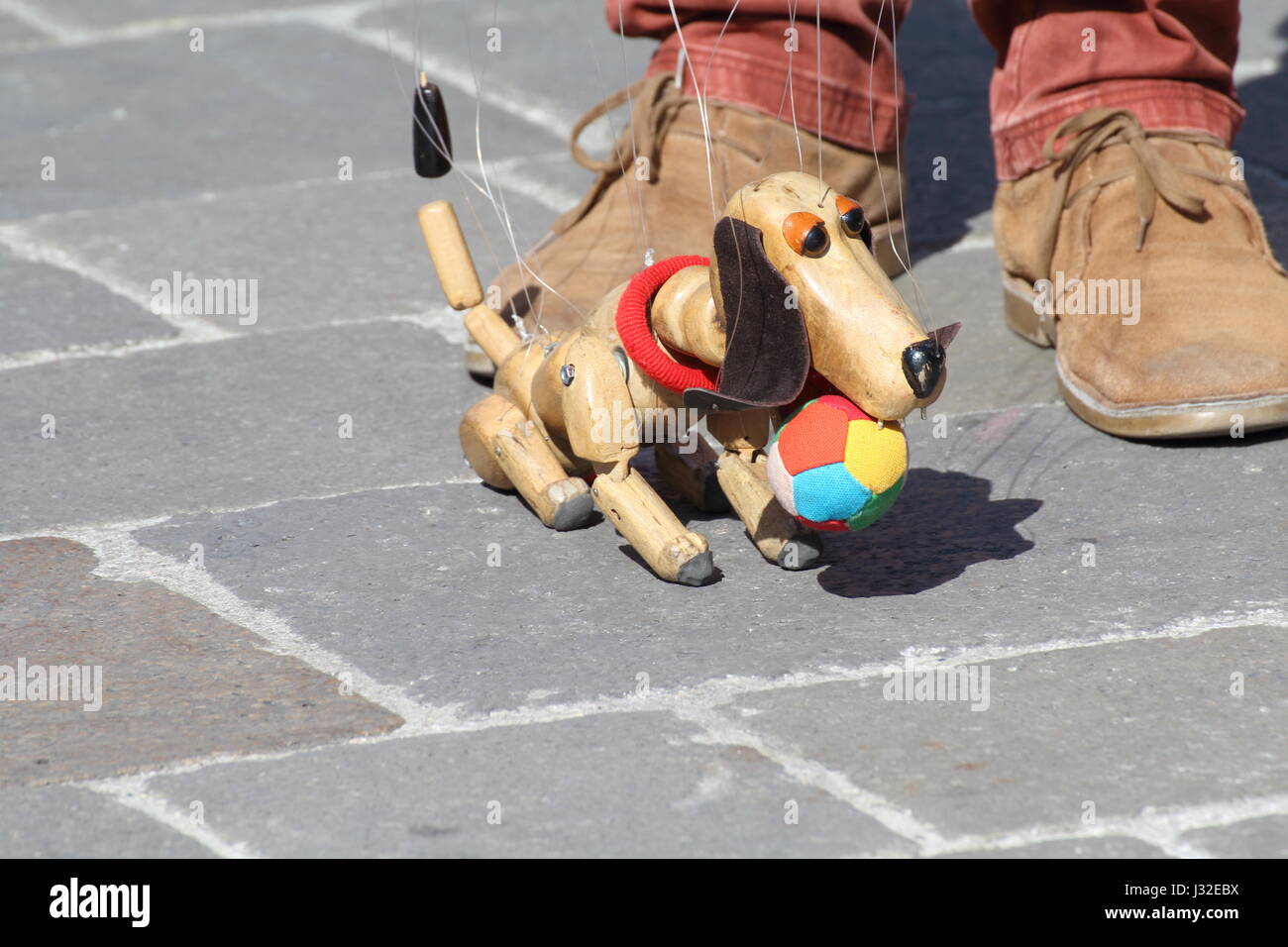 Traditional puppets made of wood. Puppet to form of dog moved by man