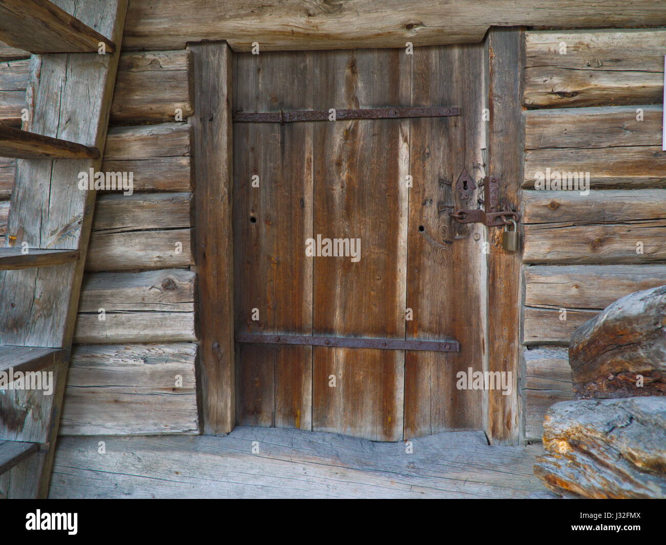 Old barn door with a rustic wall Stock Photo