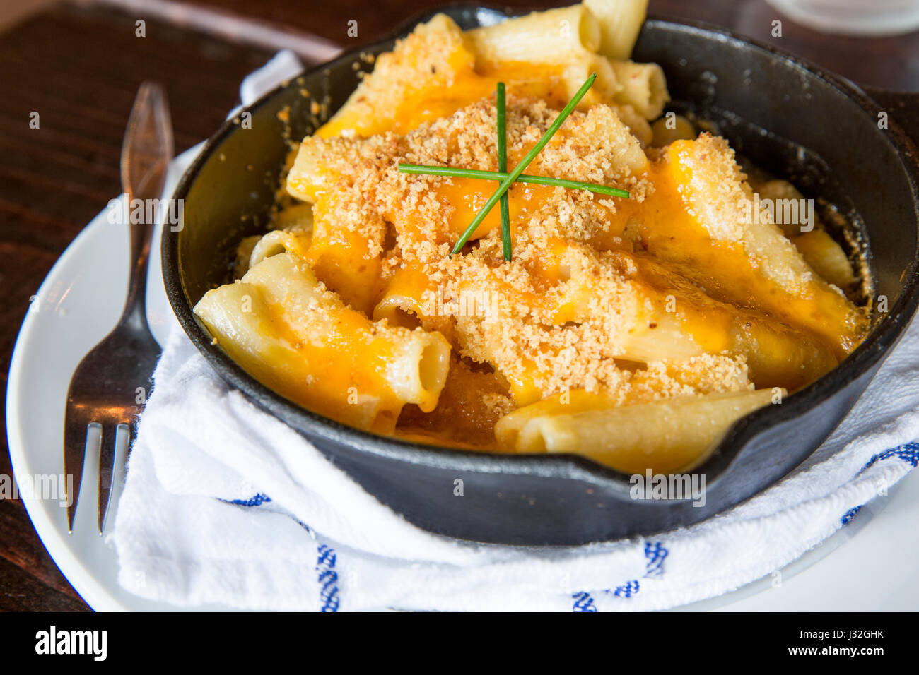 Oven baked macaroni and cheese served in a cast iron skillet at a