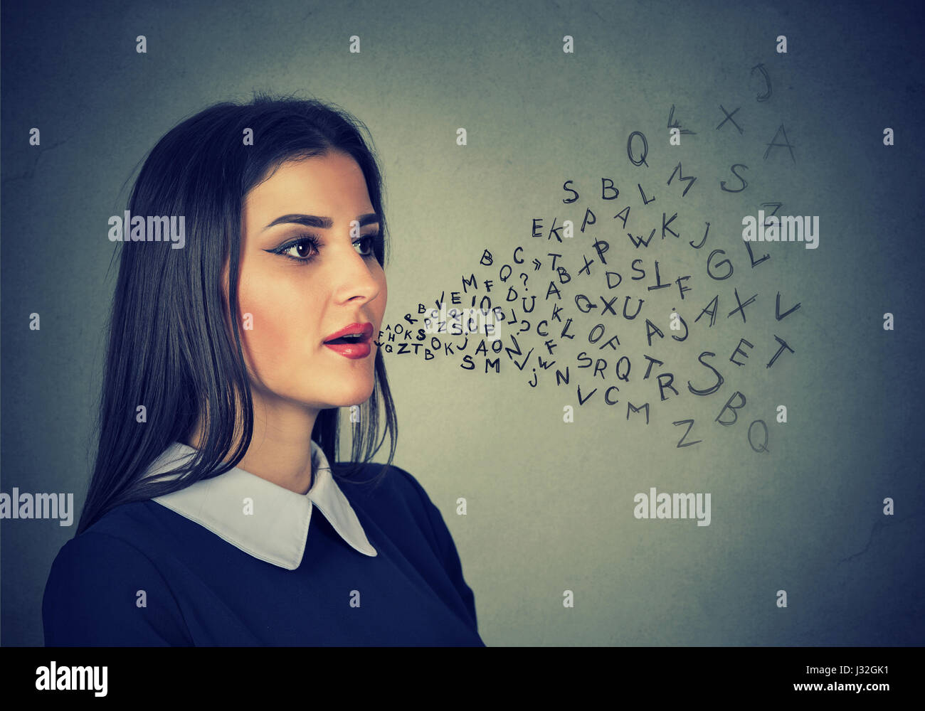 Woman talking with alphabet letters coming out of her mouth. Communication, information, intelligence concept Stock Photo