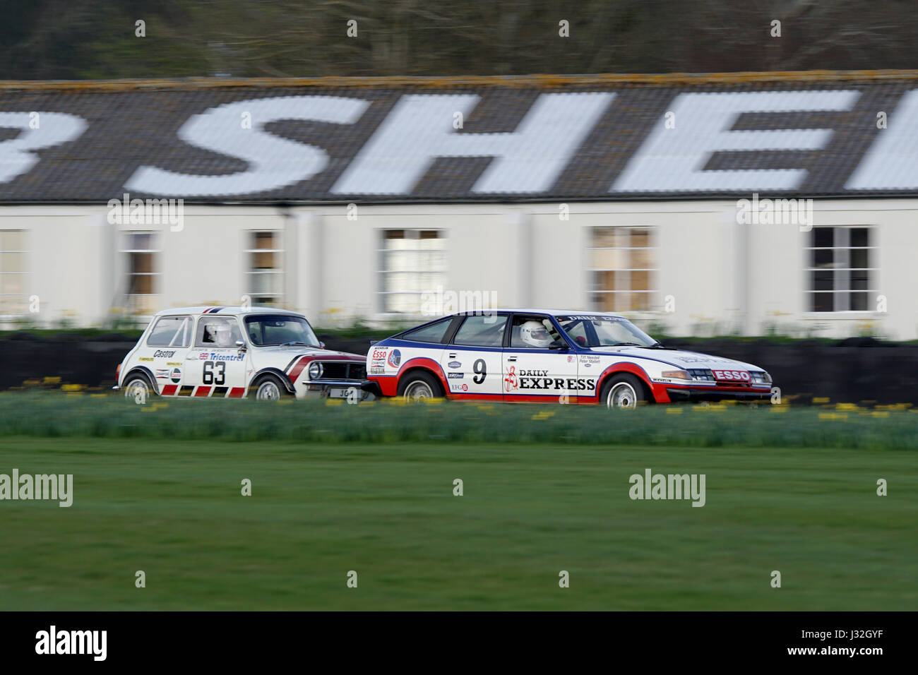 The Rover 3500 of Peter Mallett and Tiff Needell under pressure from the Mini 1275GT of Jon Mowatt and Glynn Swift at 75th Goodwood Members Meeting Stock Photo
