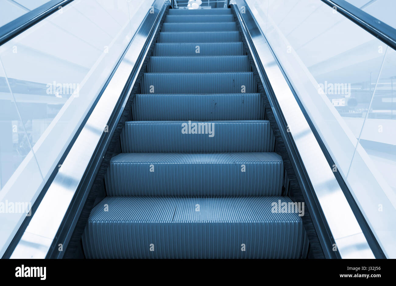 Escalator and step inside building. Stock Photo