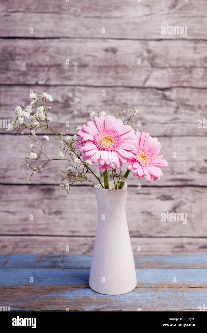 pink gerbera in white vase with wooden background Stock Photo
