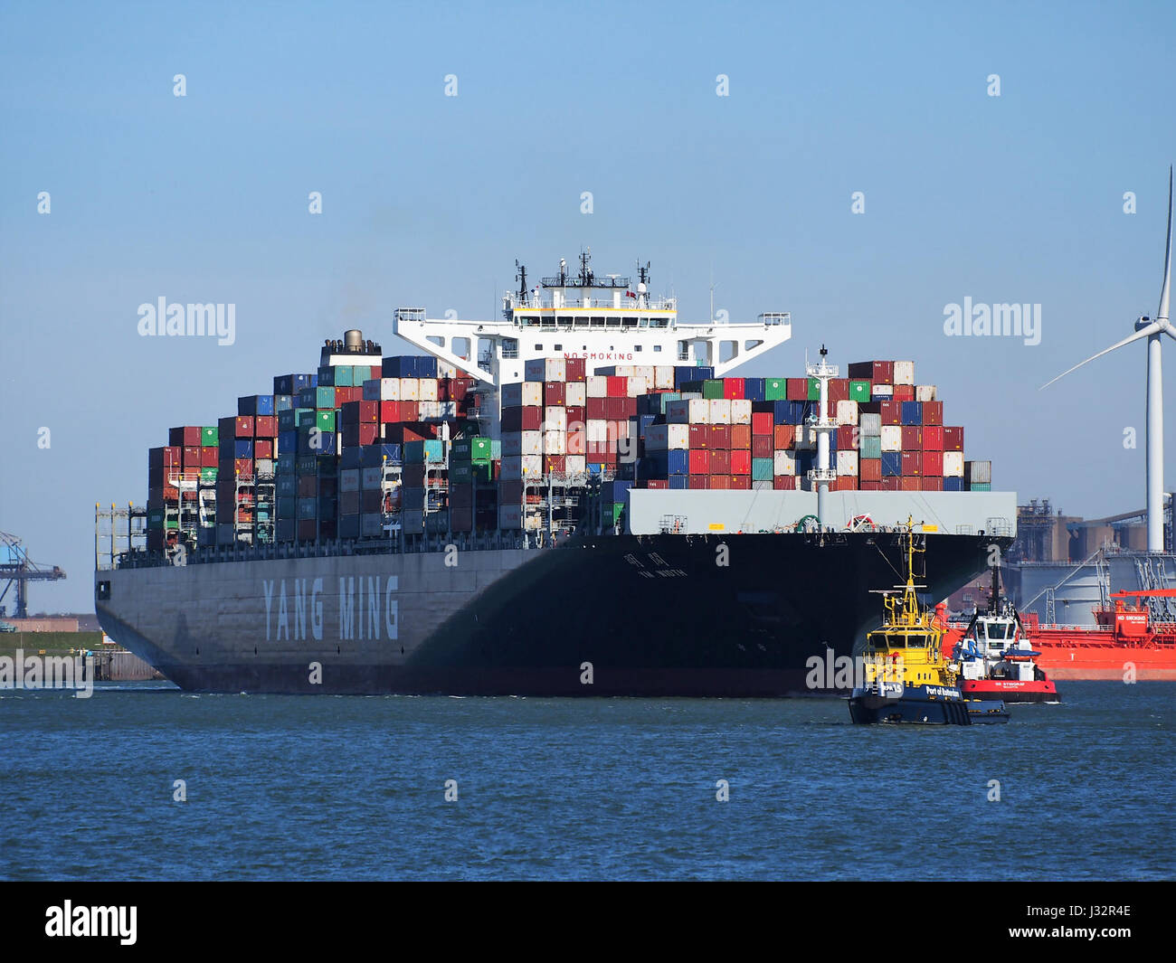 YM Width is a 2016-built vessel with IMO number 9708447, arriving at the Port of Rotterdam, a major international shipping hub in Europe. Stock Photo