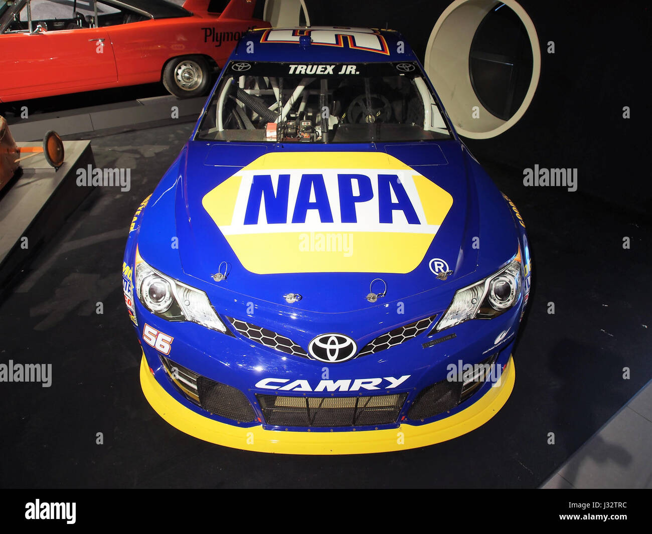 A photo showing the 2013 Toyota Camry NASCAR race car, featuring a 5.9-liter 8-cylinder engine with 850 horsepower. This car is used in professional racing events, showcasing speed and engineering design. Stock Photo