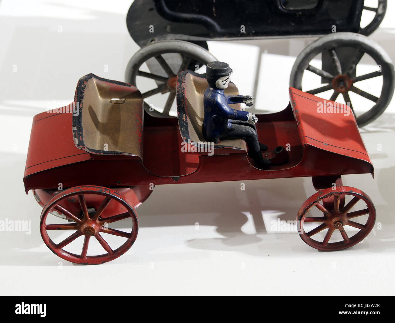 A Photograph Of A Vintage Tin Toy Car Displayed At The Louwman Museum 