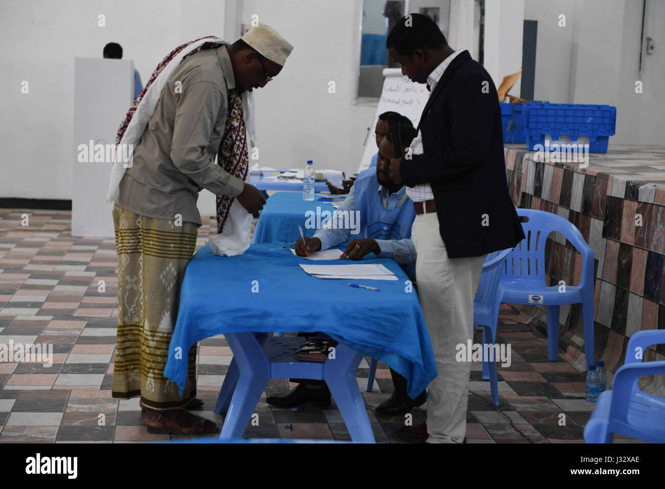 Electoral officials check the accreditation card of a delegate during the electoral process to choose Somaliland's representatives to the Upper House of the Federal Parliament in Mogadishu, Somalia, on January 8, 2017. AMISOM Photo / Omar Abdisalan Stock Photo