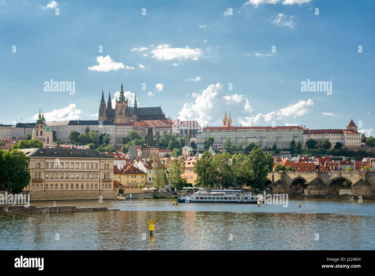 PRAGUE, CZECH REPUBLIC, JULY 5, 2016: Wide angle view of Prague Castle and the tower of St. Vitus Cathedral, famous landmarks of Prague. Stock Photo