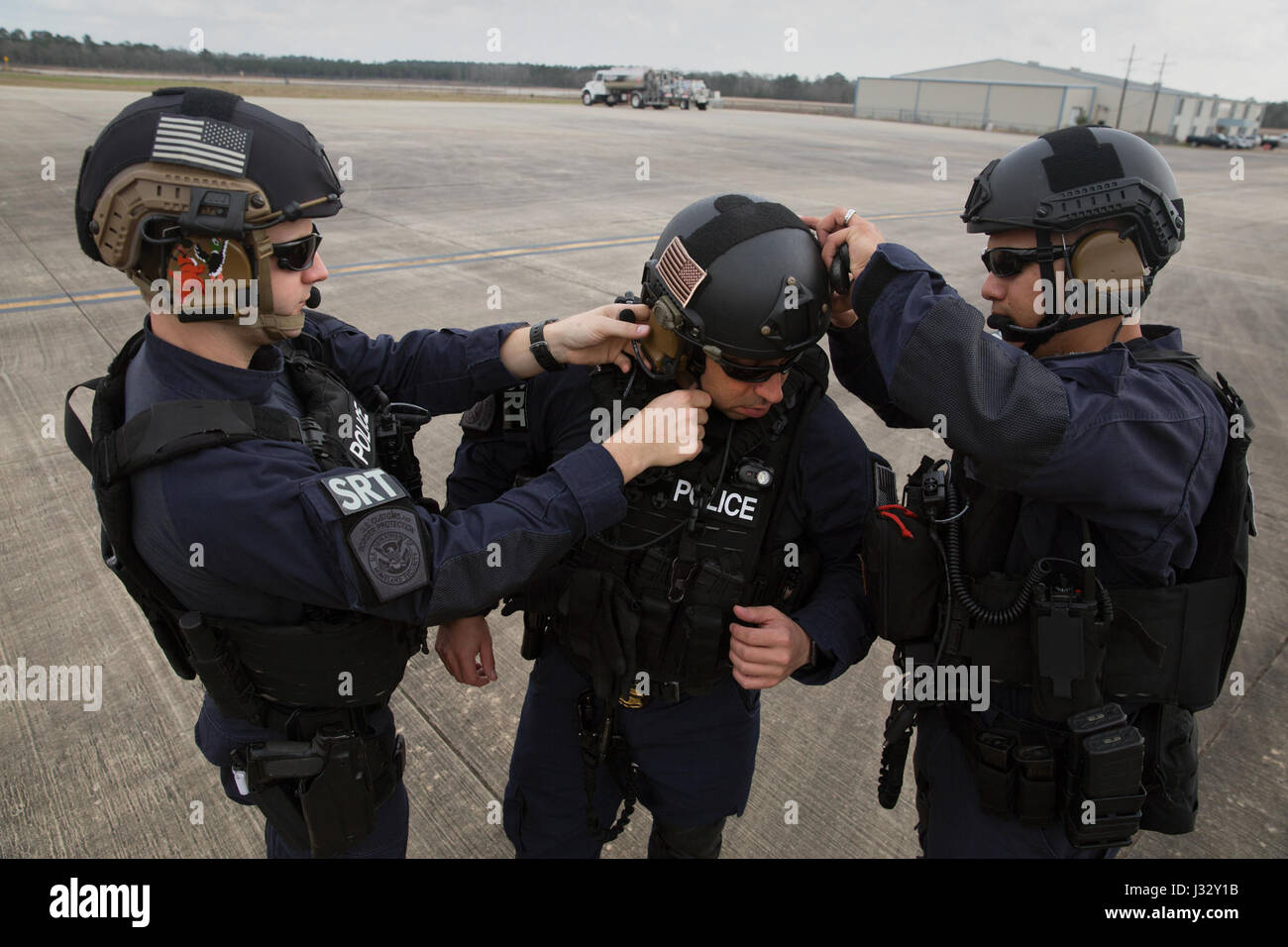 Members of the U.S. Customs and Border Protection, Office of Field Operations Special Response Team, suit-up prior to an air-intercept training exercise as they provide airspace security for Super Bowl LI, in Conroe, Texas, Feb. 1, 2017. Units with Air and Marine Operations and Office of Field Operations teamed up with the Civil Air Patrol  to practice an air-to-air intercept using two AMO UH-60 Black Hawk helicopters and two C-550 Citation jets to track down a simulated incursion into restricted airspace. U.S. Customs and Border Protection Photo by Glenn Fawcett Stock Photo