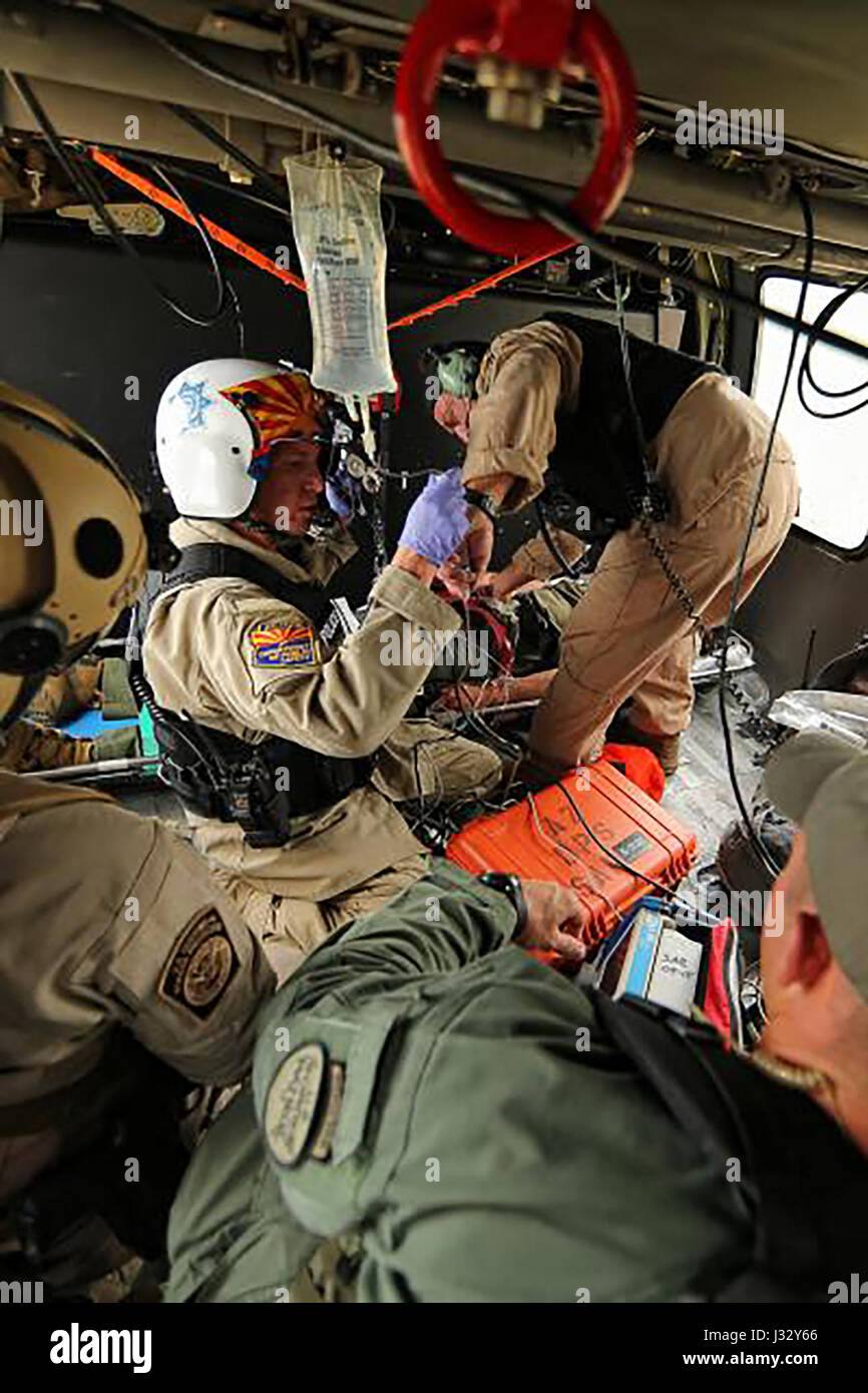 TUCSON, Ariz. – Tucson Sector Border Patrol, Air and Marine Operations (AMO) and Arizona Department of Public Safety (AZDPS) jointly rescued migrants during three complex operations within the last six weeks in Arizona’s rugged desert.  The first joint rescue occurred on Jan. 8 when a Honduran national was extracted from the bottom of a 400-foot cliff near Three Points. The man was left behind by his traveling partner due to a broken ankle. Border Patrol Search and Trauma (BORSTAR) agents deployed from an AMO helicopter and located the man in a precarious area. Agents were joined by AZDPS para Stock Photo