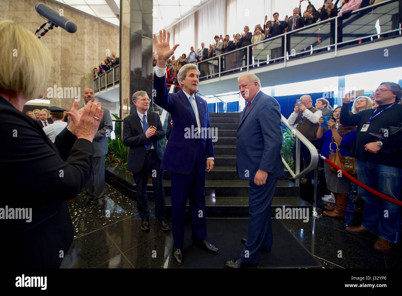 U.S. Secretary of State John Kerry waves to the crowd, as they gathered in the main lobby of the Department's Harry S. Truman building, before delivering farewell remarks on January 19, 2017. Stock Photo