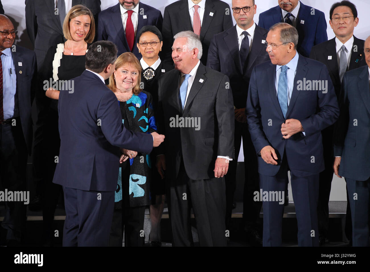 U.S. Secretary of State Rex Tillerson engaging in discussions with foreign counterparts before a family photo during the G-20 Foreign Ministers' Meeting in Bonn, Germany. Stock Photo