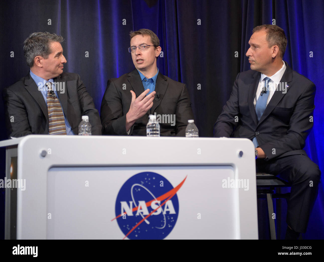 Manager of NASA's Spitzer Science Center at Caltech/IPAC, Pasadena, California Sean Carey, left, University of Liege in Belgium Astronomer Michael Gillon, center, and NASA Associate Administrator of the Science Mission Directorate Thomas Zurbuchen present research findings during a TRAPPIST-1 planets briefing, Wednesday, Feb. 22, 2017 at NASA Headquarters in Washington. Researchers revealed the first known system of seven Earth-size planets around a single star called TRAPPIST-1. Photo Credit: (NASA/Bill Ingalls)  More: exoplanets.nasa.gov/trappist1/ ( https://exoplanets.nasa.gov/trappist1/ ) Stock Photo