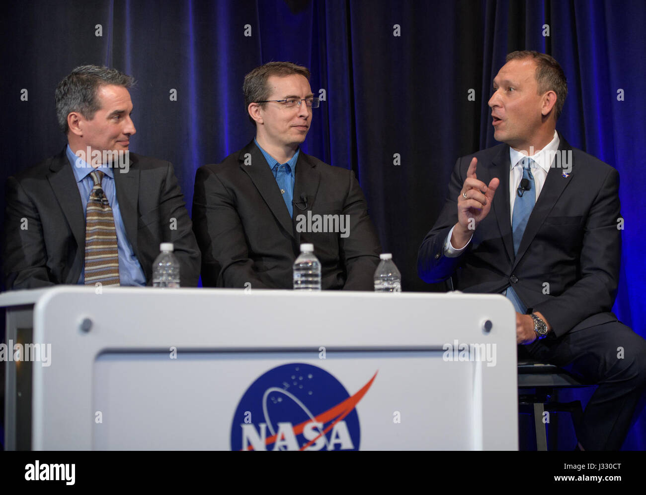 Manager of NASA's Spitzer Science Center at Caltech/IPAC, Pasadena, California Sean Carey, left, University of Liege in Belgium Astronomer Michael Gillon, center, and NASA Associate Administrator of the Science Mission Directorate Thomas Zurbuchen present research findings during a TRAPPIST-1 planets briefing, Wednesday, Feb. 22, 2017 at NASA Headquarters in Washington. Researchers revealed the first known system of seven Earth-size planets around a single star called TRAPPIST-1. Photo Credit: (NASA/Bill Ingalls)  More: exoplanets.nasa.gov/trappist1/ ( https://exoplanets.nasa.gov/trappist1/ ) Stock Photo