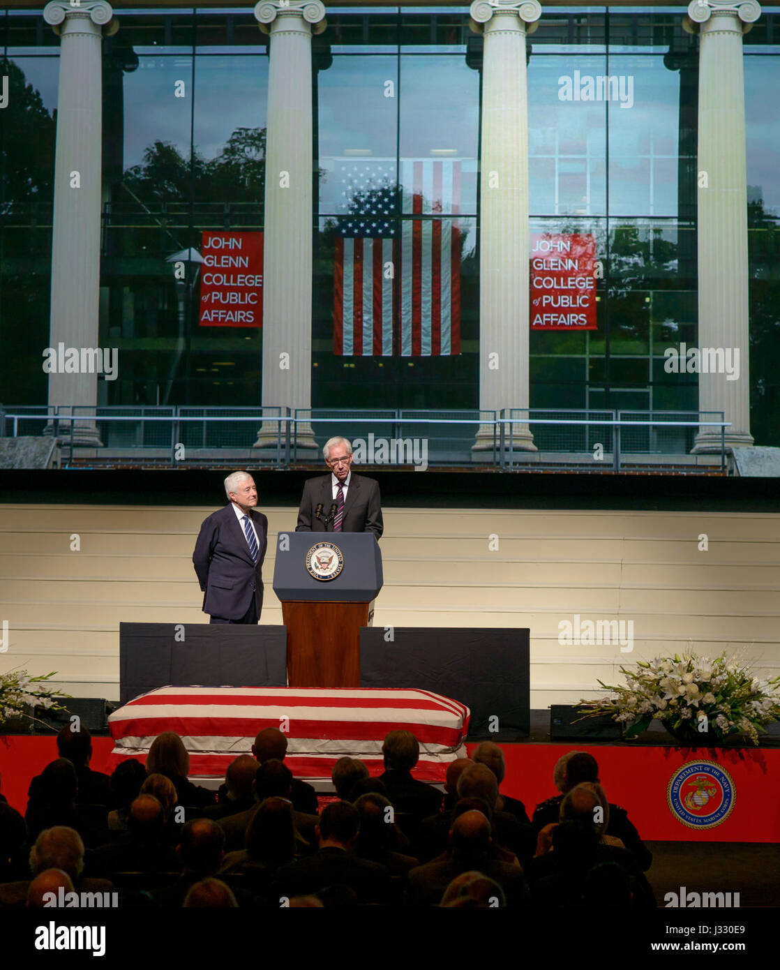 Cincinnati banker and hotelier Louis Beck speaks as New Albany Company Cofounder and Chairman Jack Kessler looks on during a service celebrating the life of former astronaut and U.S. Senator John Glenn, Saturday, Dec. 17, 2016 at The Ohio State University, Mershon Auditorium in Columbus. Photo Credit: (NASA/Bill Ingalls) Stock Photo