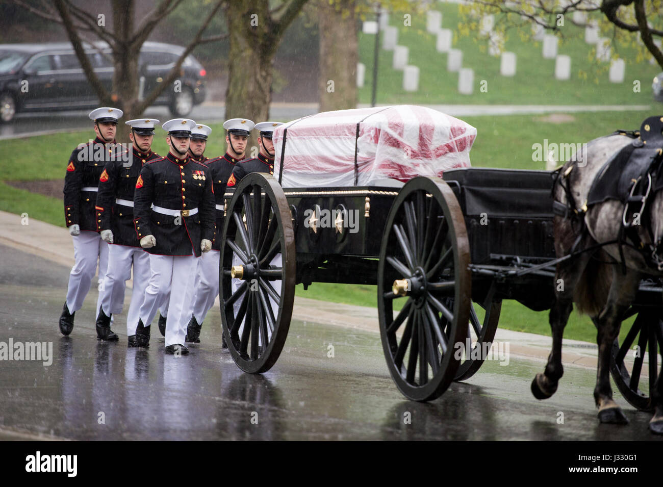 A horse drawn caisson carries former astronaut and U.S. Senator John Glenn to his final resting place during the interment ceremony at Arlington National Cemetery on Thursday, April 6, 2017 in Virginia. Glenn was the first American to orbit Earth on Feb. 20, 1962, in a five-hour flight aboard the Friendship 7 spacecraft. In 1998, he broke another record by returning to space at the age of 77 on the Space Shuttle Discovery. Photo Credit: (NASA/Aubrey Gemignani) Stock Photo