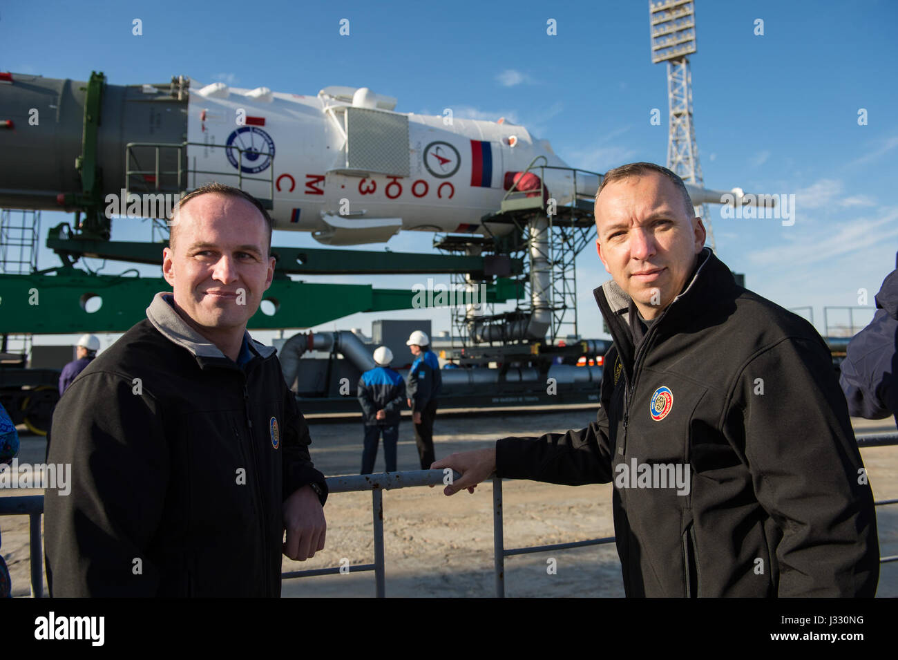 The Expedition 51 backup crew, Soyuz Commander Sergey Ryazanskiy of Roscosmos, left, and Flight Engineer Randy Bresnik of NASA, right, are photographed in front of the Soyuz MS-04 spacecraft as it arrives at the launch pad by train on Monday, April 17, 2017 at the Baikonur Cosmodrome in Kazakhstan.  Launch of the Soyuz rocket is scheduled for April 20 Baikonur time and will send Expedition 51 prime crew, Soyuz Commander Fyodor Yurchikhin of Roscosmos and Flight Engineer Jack Fischer of NASA on a four and a half month mission aboard the International Space Station. Photo Credit: (NASA/Aubrey Ge Stock Photo