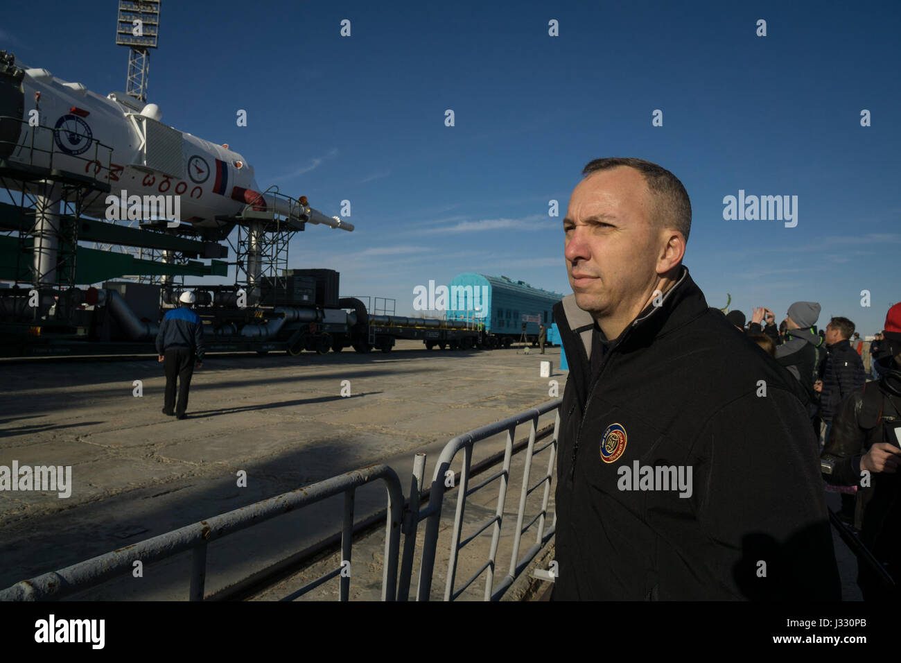The Expedition 51 backup crew member, Randy Bresnik of NASA, watches as the Soyuz MS-04 spacecraft arrives at the launch pad by train on Monday, April 17, 2017 at the Baikonur Cosmodrome in Kazakhstan.  Launch of the Soyuz rocket is scheduled for April 20 Baikonur time and will send Expedition 51 prime crew, Soyuz Commander Fyodor Yurchikhin of Roscosmos and Flight Engineer Jack Fischer of NASA on a four and a half month mission aboard the International Space Station. Photo Credit: (NASA/Victor Zelentsov) Stock Photo