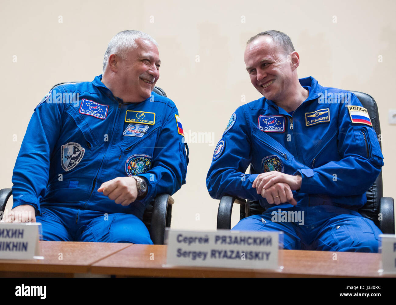 Expedition 51 prime crew member Soyuz Commander Fyodor Yurchikhin of Roscosmos, left, laughs with Expedition 51 backup crew member Sergey Ryazanskiy of Roscosmos during a press conference on Wednesday, April 19, 2017 at the Cosmonaut Hotel in Baikonur, Kazakhstan. Launch of the Soyuz rocket is scheduled for April 20 and will carry Yurchikhin and Flight Engineer Jack Fischer of NASA into orbit to begin their four and a half month mission on the International Space Station. Photo Credit: (NASA/Aubrey Gemignani). Stock Photo