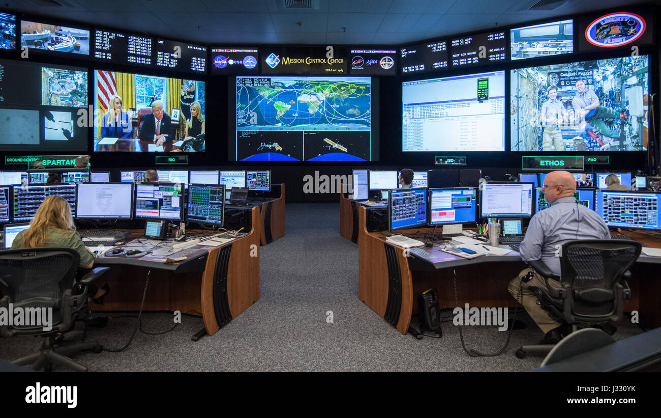 On April 24, 2017, Flight Director Brian Smith, Capcom Astronaut Jessica Meir, and Astronaut Jeff Williams were present in Mission Control during a special Earth-to-space call made by President Donald Trump, Ivanka Trump, and NASA astronaut Kate Rubins. The call was made to congratulate astronaut Peggy Whitson for her record-breaking stay aboard the International Space Station. Stock Photo