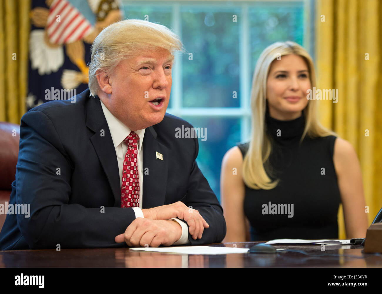 President Donald Trump, joined by First Daughter Ivanka Trump talks with NASA astronauts Peggy Whitson and Jack Fischer onboard the International Space Station Monday, April 24, 2017 from the Oval Office of the White House in Washington. The President congratulated Whitson for breaking the record for cumulative time spent in space by a U.S. astronaut. The President and First Daughter were also joined by NASA astronaut Kate Rubins and discussed with the three astronauts what it is like to live and work on the orbiting outpost as well as the importance of STEM.  Photo Credit: (NASA/Bill Ingalls) Stock Photo