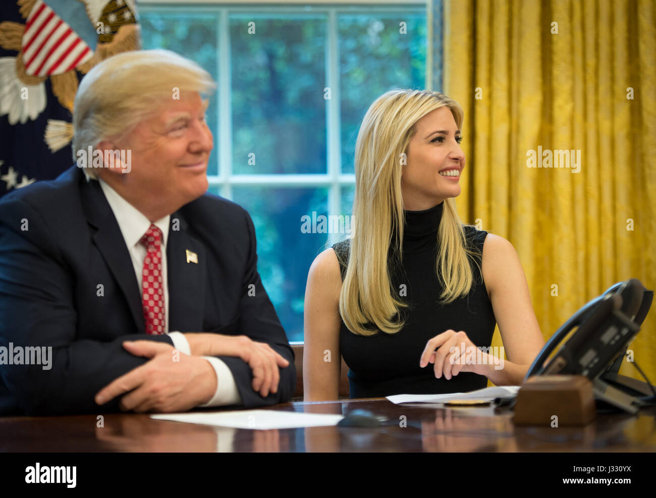 President Donald Trump, joined by First Daughter Ivanka Trump talks with NASA astronauts Peggy Whitson and Jack Fischer onboard the International Space Station Monday, April 24, 2017 from the Oval Office of the White House in Washington. The President congratulated Whitson for breaking the record for cumulative time spent in space by a U.S. astronaut. The President and First Daughter were also joined by NASA astronaut Kate Rubins and discussed with the three astronauts what it is like to live and work on the orbiting outpost as well as the importance of STEM.  Photo Credit: (NASA/Bill Ingalls) Stock Photo