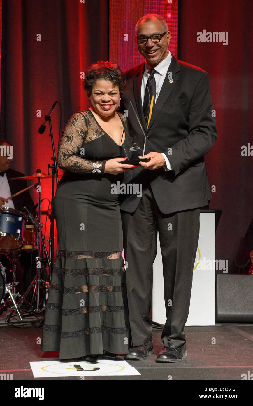 NASA Associate Administrator for Education Donald James, right, presents  Janet Sellars, acting associate administrator for Diversity and Equal Opportunity at NASA Headquarters, with the Corporate Promotion of Education award during the 31st Black Engineer of the Year Awards Gala on Saturday, Feb. 11, 2017 at the Washington Marriott Wardman Park Hotel in Washington, DC.  Sellars was presented the Corporate Promotion of Education award and Allen Parker, a research engineer at NASA's Armstrong Flight Research Center was presented with the Career Achievement in Government award during the event. Stock Photo