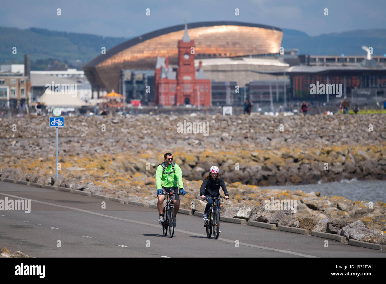 Cyclists ride on Cardiff Bay barrage during the warm sunny weather on