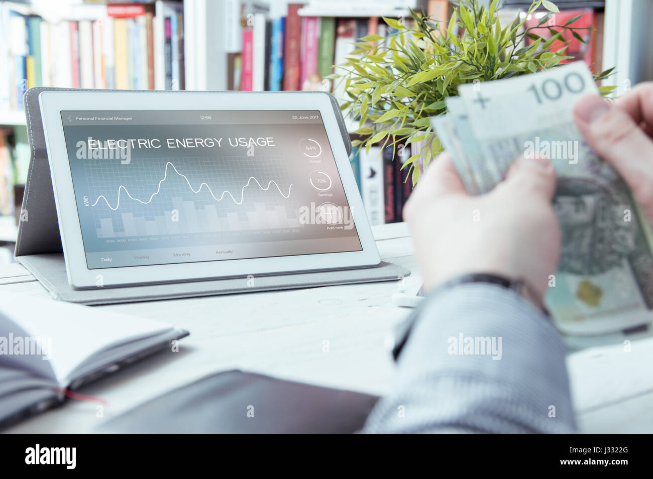 Electric energy usage application made in graphic program and man holding money Stock Photo