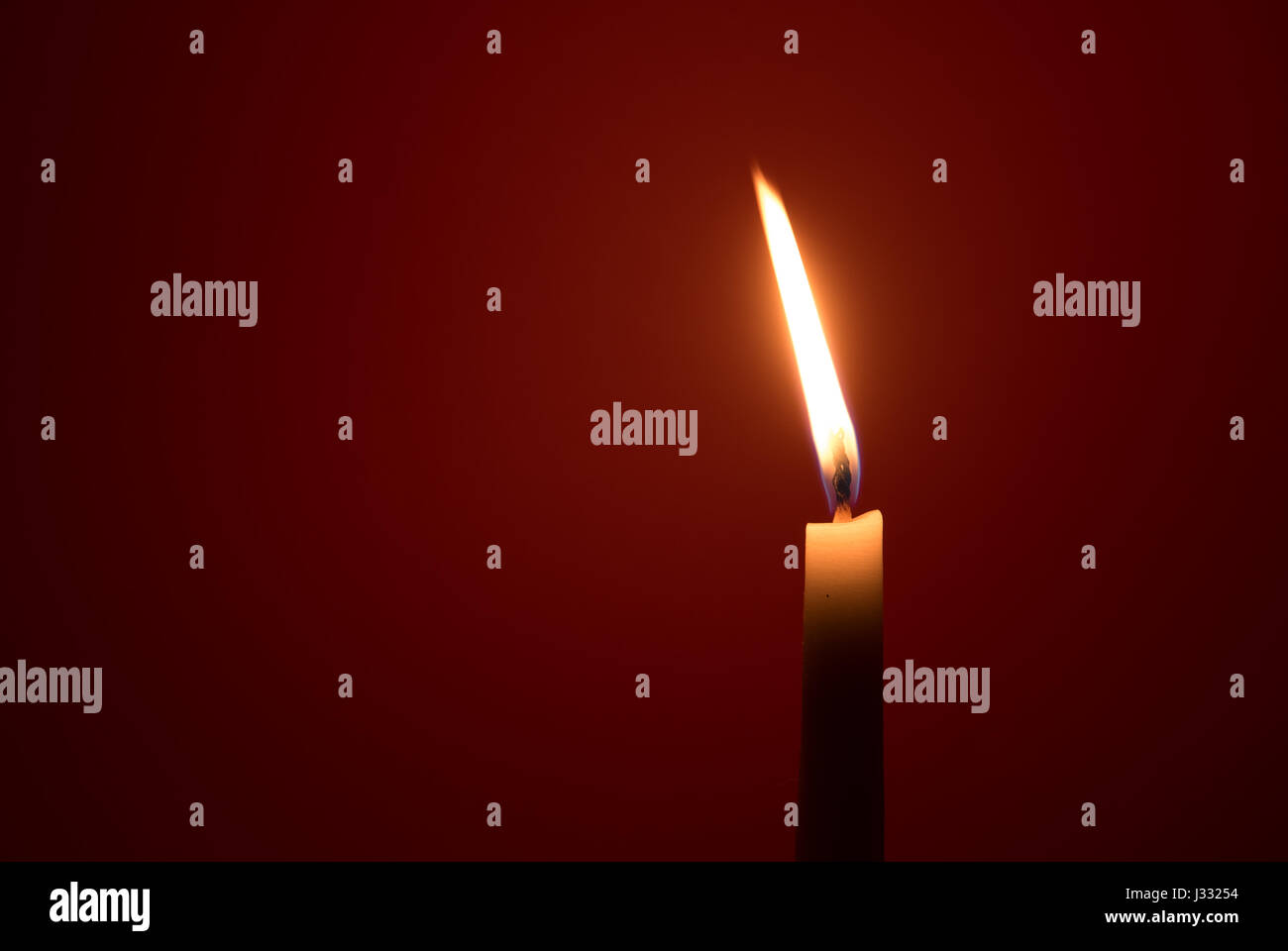 Holy religious white candle burning creating a mysterious atmosphere on