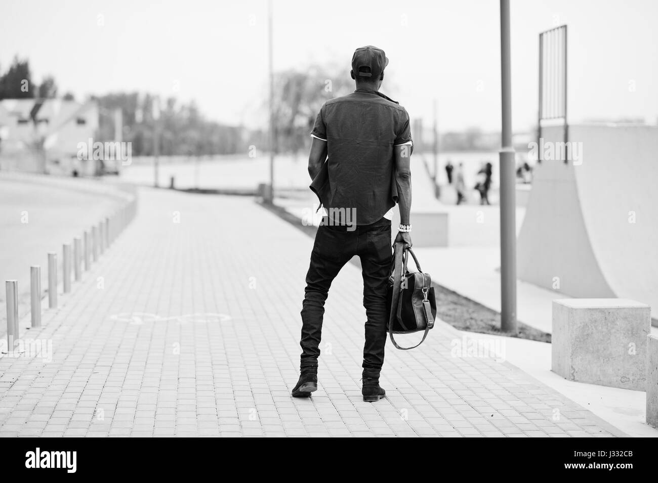 Stylish black man walking along street on sunny day - a Royalty Free Stock  Photo from Photocase